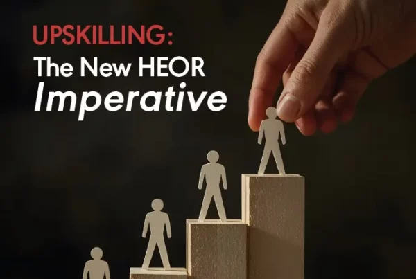 ISPOR Value and Outcomes Spotlight magazine cover for September October 2025 featuring a hand placing a wooden figure on a rising block chart with the headline Upskilling The New HEOR Imperative.