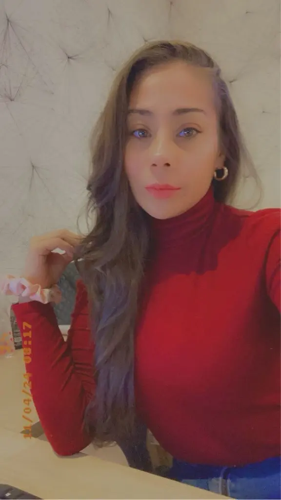 Vanessa Marrero wearing a red turtleneck sweater